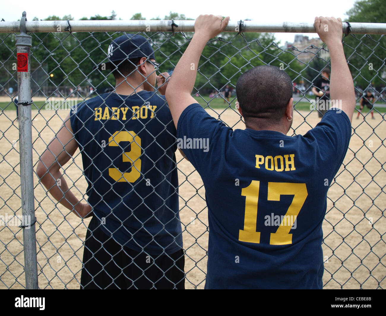 Two ball players watching game, McCarren Park, Brooklyn, New York Stock Photo