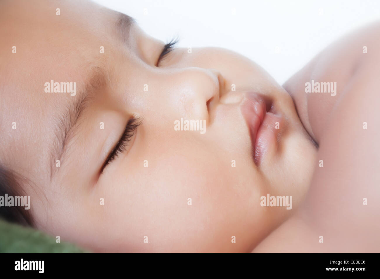 Cute 13 month old baby sleeping or dreaming peacefully during the day Stock Photo