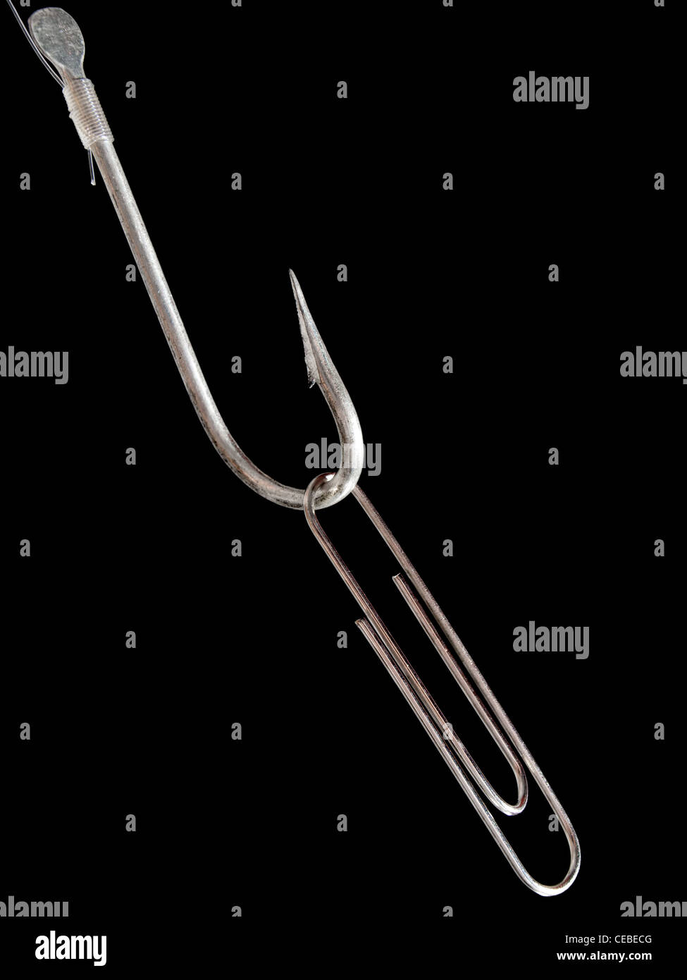 Paperclip on a fishing hook as a bait on a black background Stock Photo