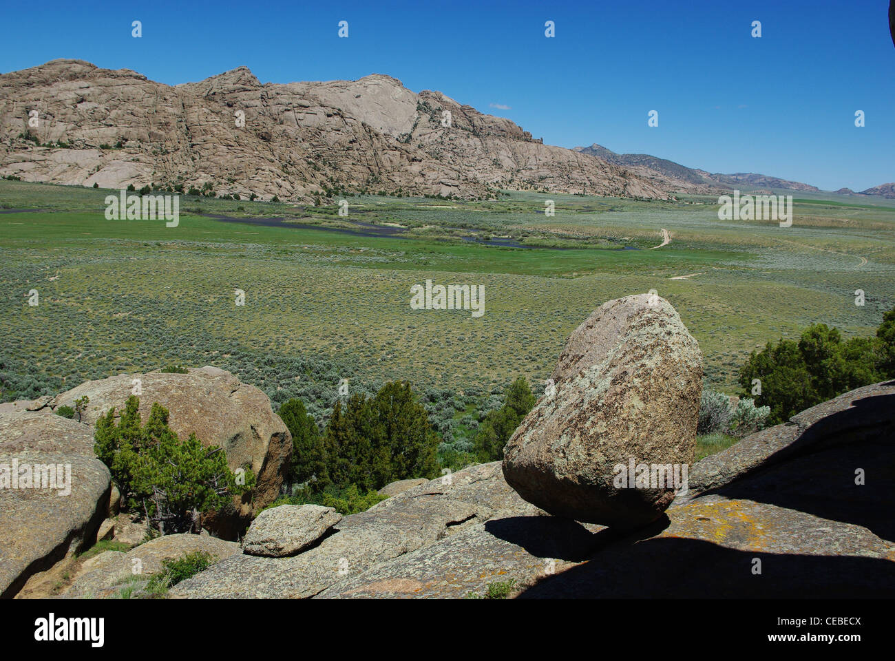 Boulder, rocks and green river valley, Split Rock, Wyoming Stock Photo