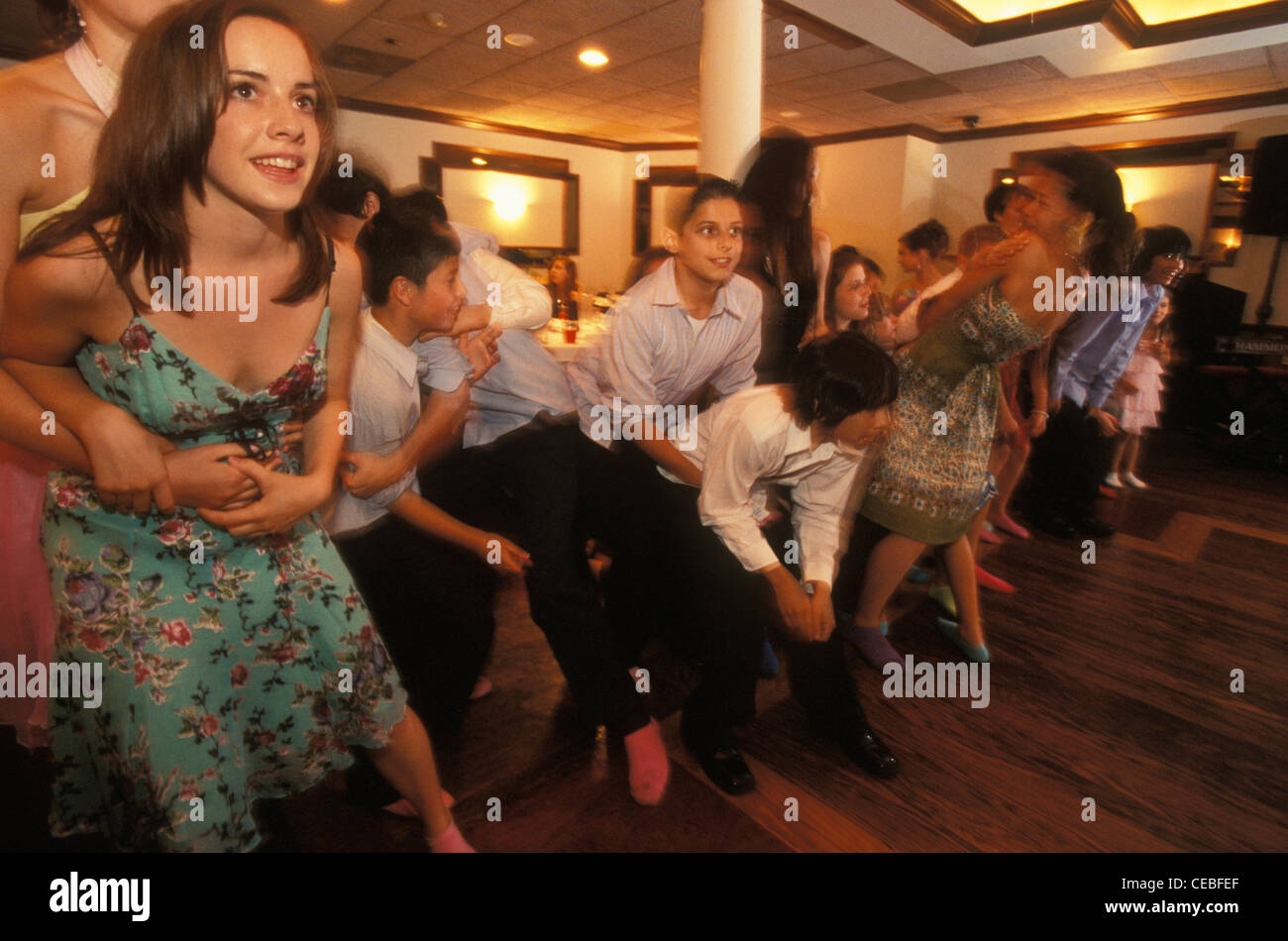 Young friends and relatives of a Jewish girl play games at her bat mitzvah party in a restaurant in New Jersey, USA Stock Photo