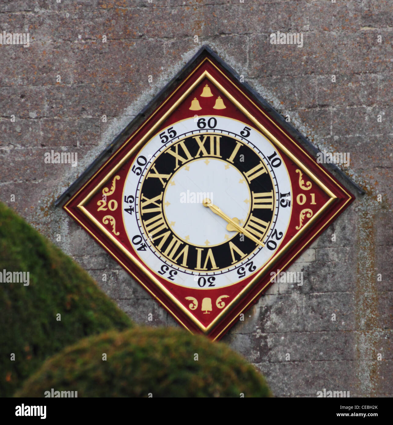 Church clock, St Mary's, Painswick, Gloucestershire.  Restored in 2001, with Yew tree emblem. Stock Photo