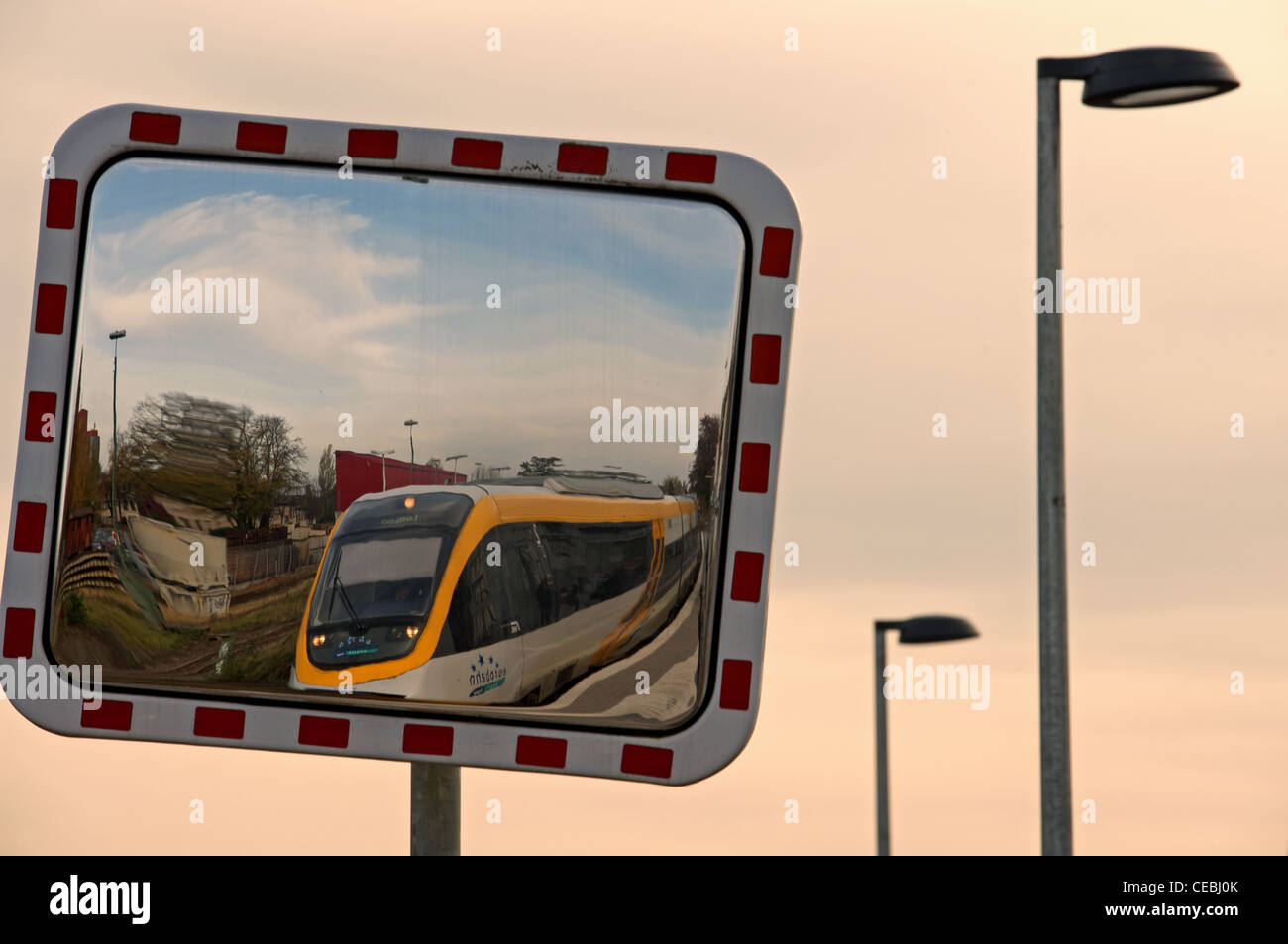 Passenger train reflected in station platform mirror Stock Photo Alamy