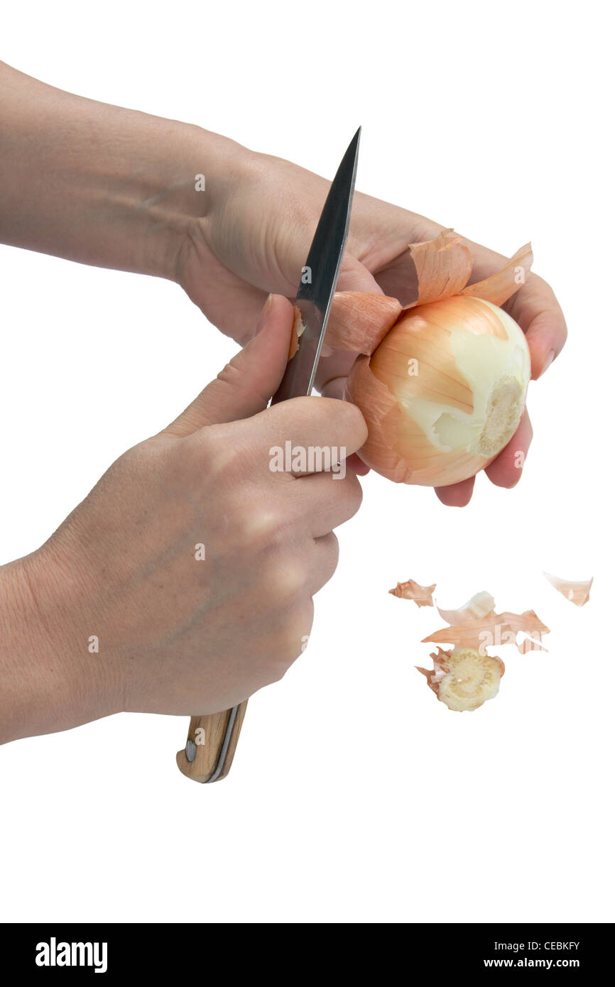 Cleaning the onion, isolated on white background Stock Photo - Alamy
