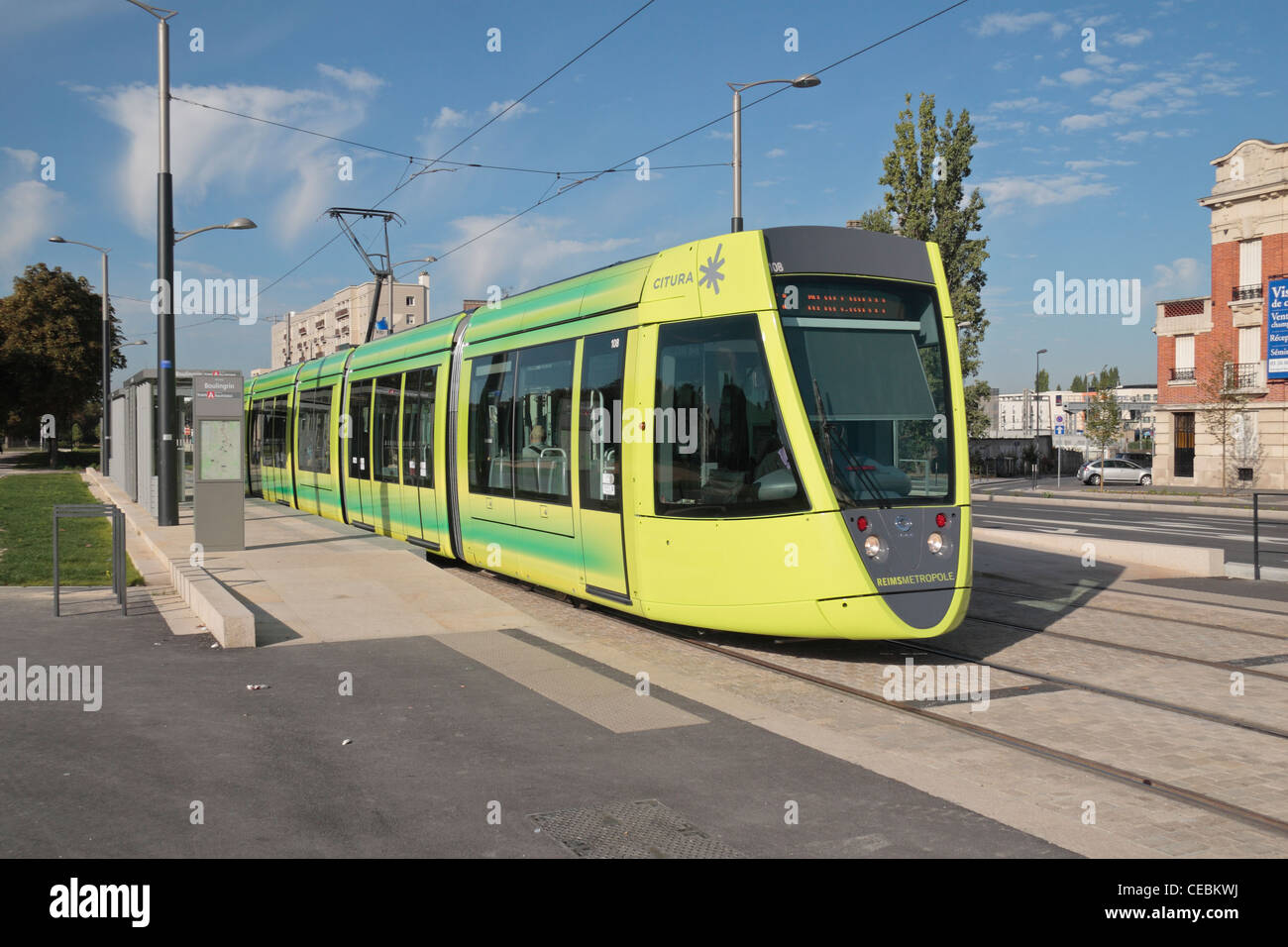 A bright yellow city tram (by Citura) on Boulevard Joffre in Riems, Champagne-Ardenne, France. Stock Photo