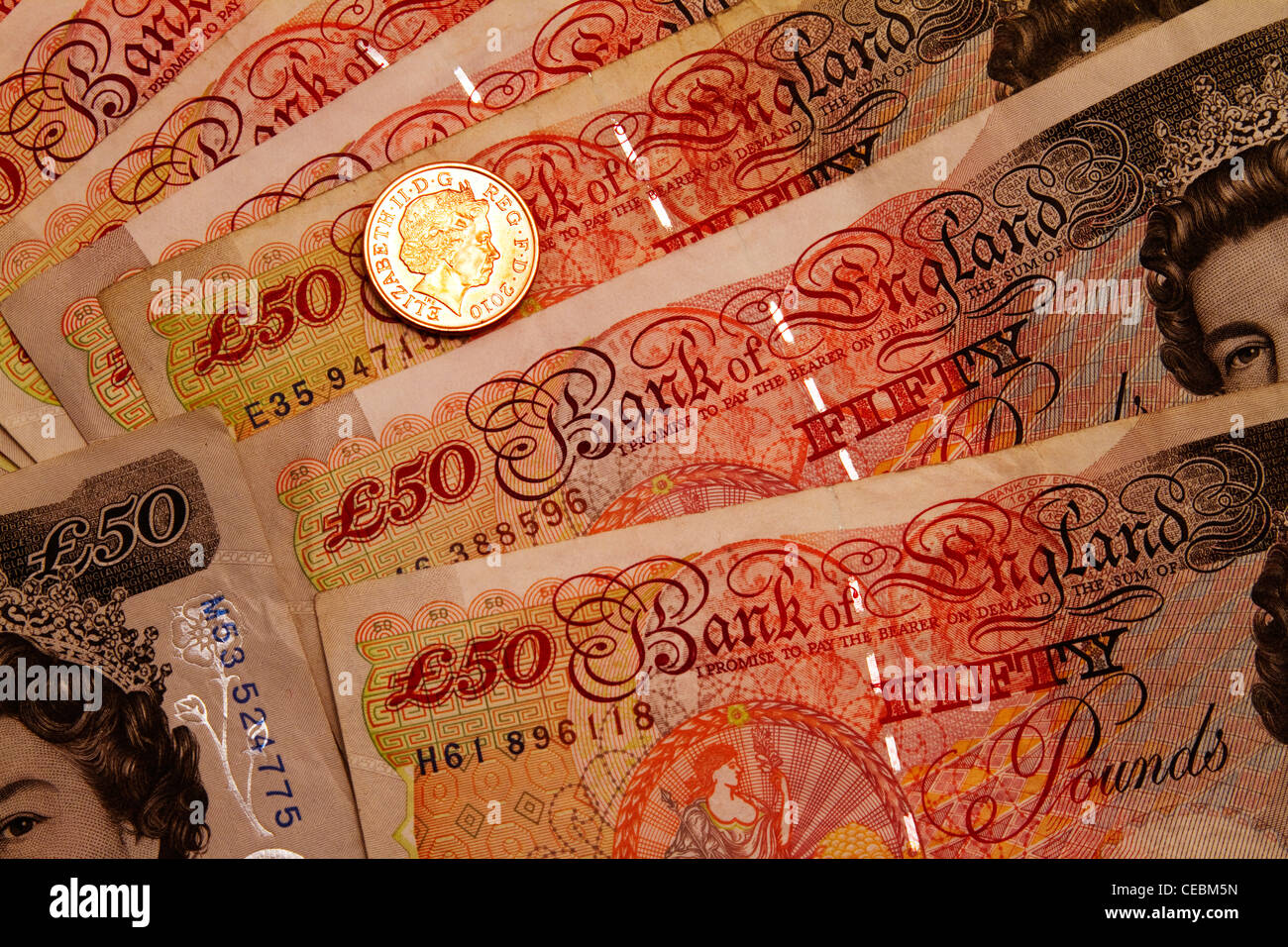 Fifty Pound notes and one pence Stock Photo