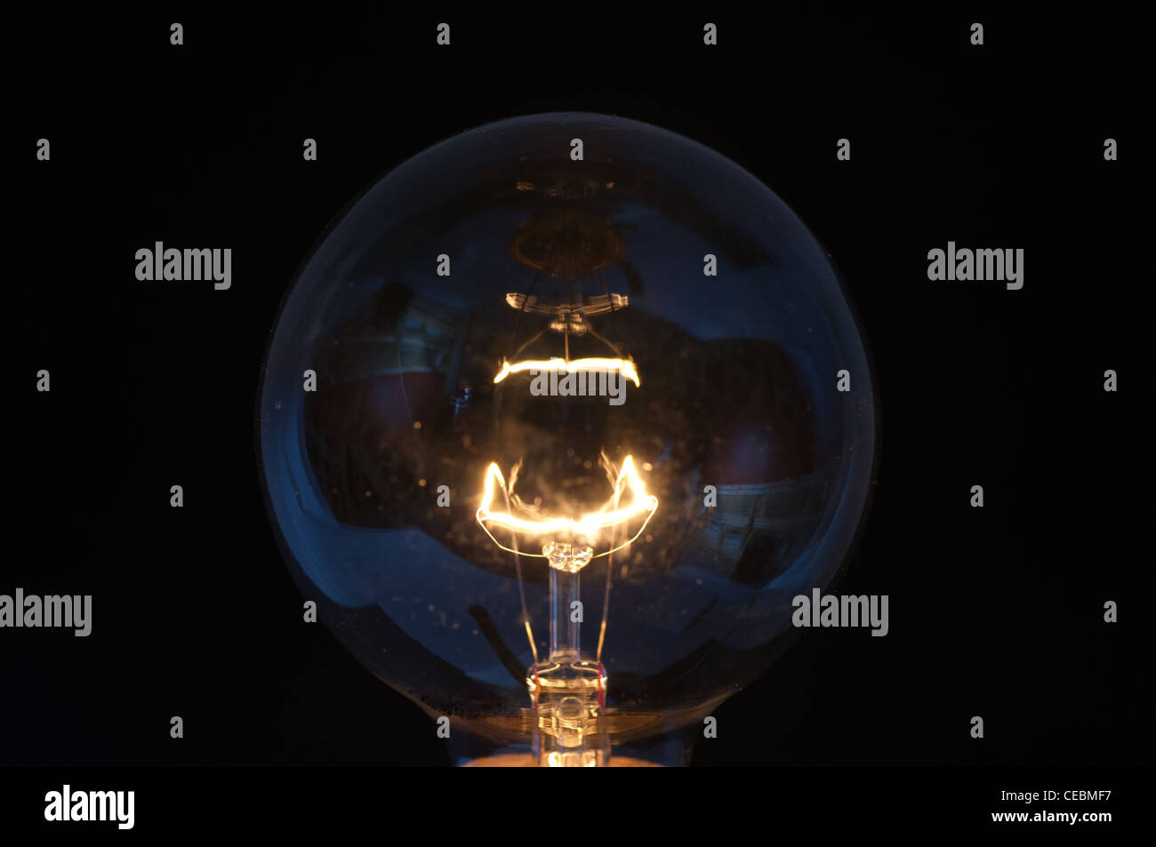 Close up of light bulb filament and glass glowing Stock Photo Alamy