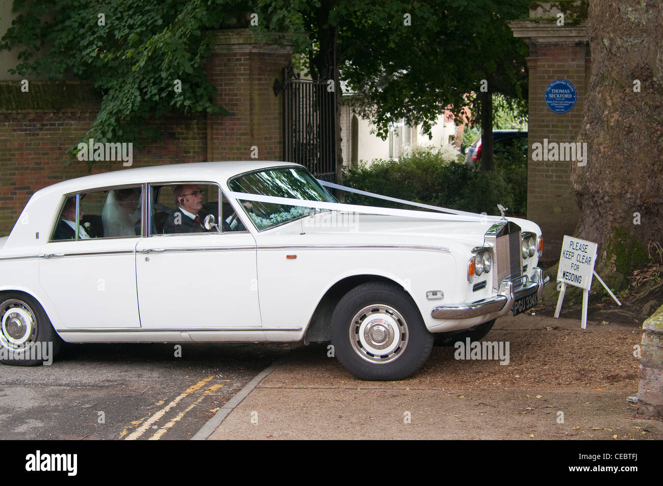 Bride and groom in white Rolls Royce entering St. Mary's Church in ...