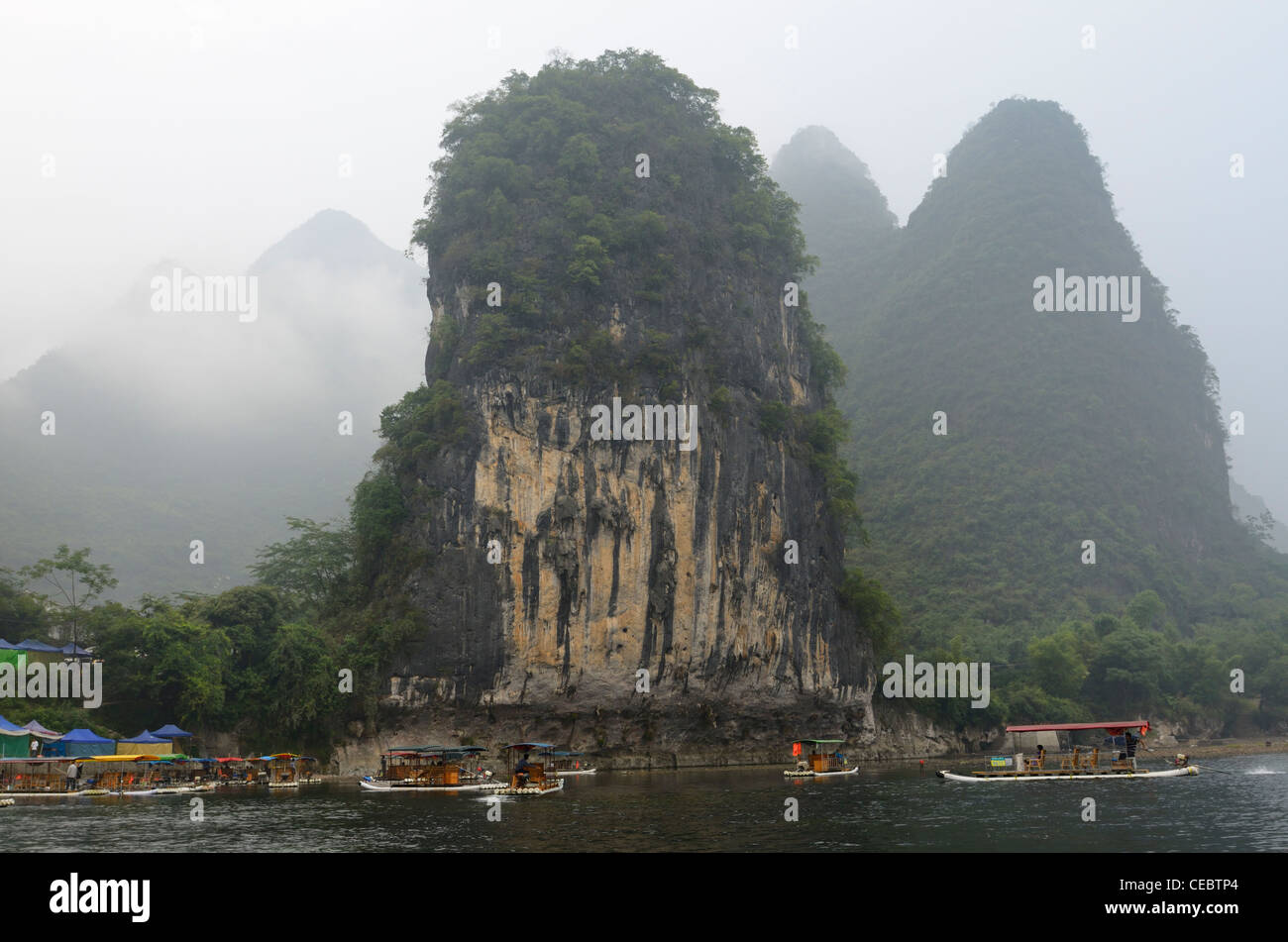 Steep pointed Karst limestone peaks and tour boats on the Li river at Xingping Peoples Republic of China Stock Photo