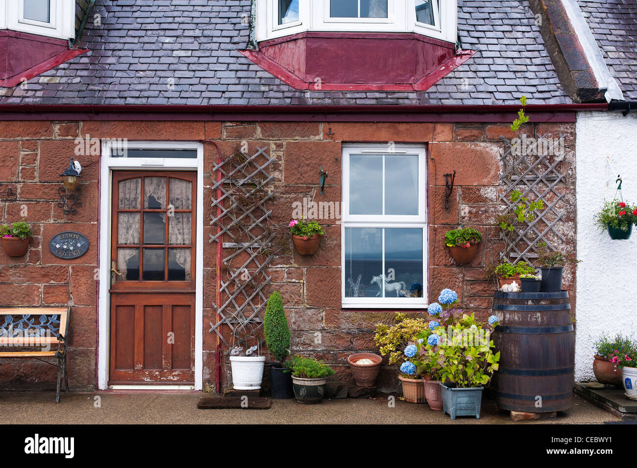A quaint cottage facade in the tiny an cute village of Skipness on the Kintyre in Western Scotland Stock Photo