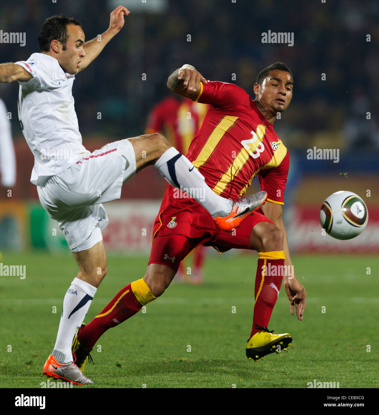 Landon Donovan of the USA (L) kicks the ball in front of Kevin Prince Boateng of Ghana (R) during a FIFA World Cup match. Stock Photo