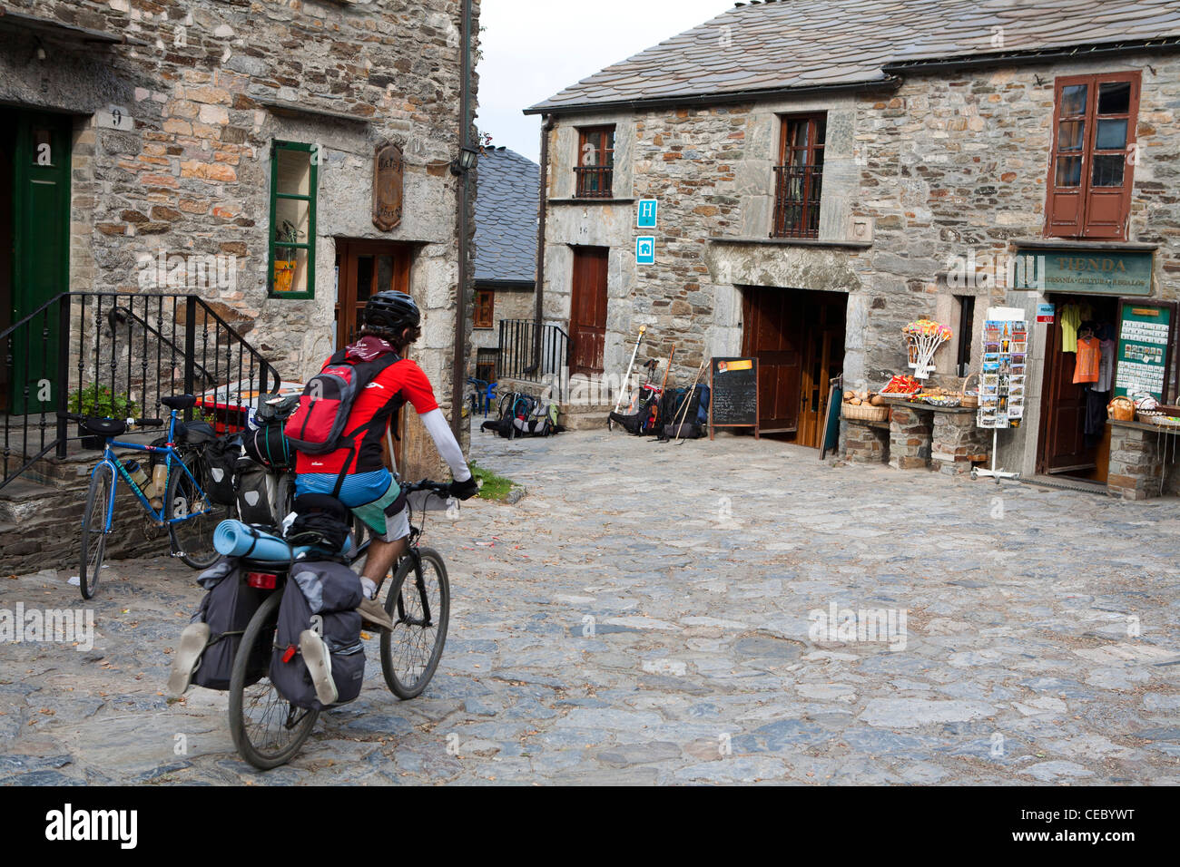 Camino de Santiago cyclist in O Cebreiro, atop the pilgrimage's most nortorious climb Stock Photo