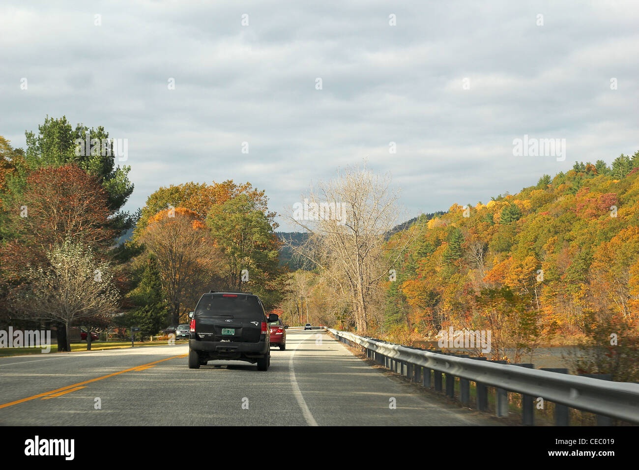Autumn foliage surrounds a road near Brattleboro, Vermont Stock Photo