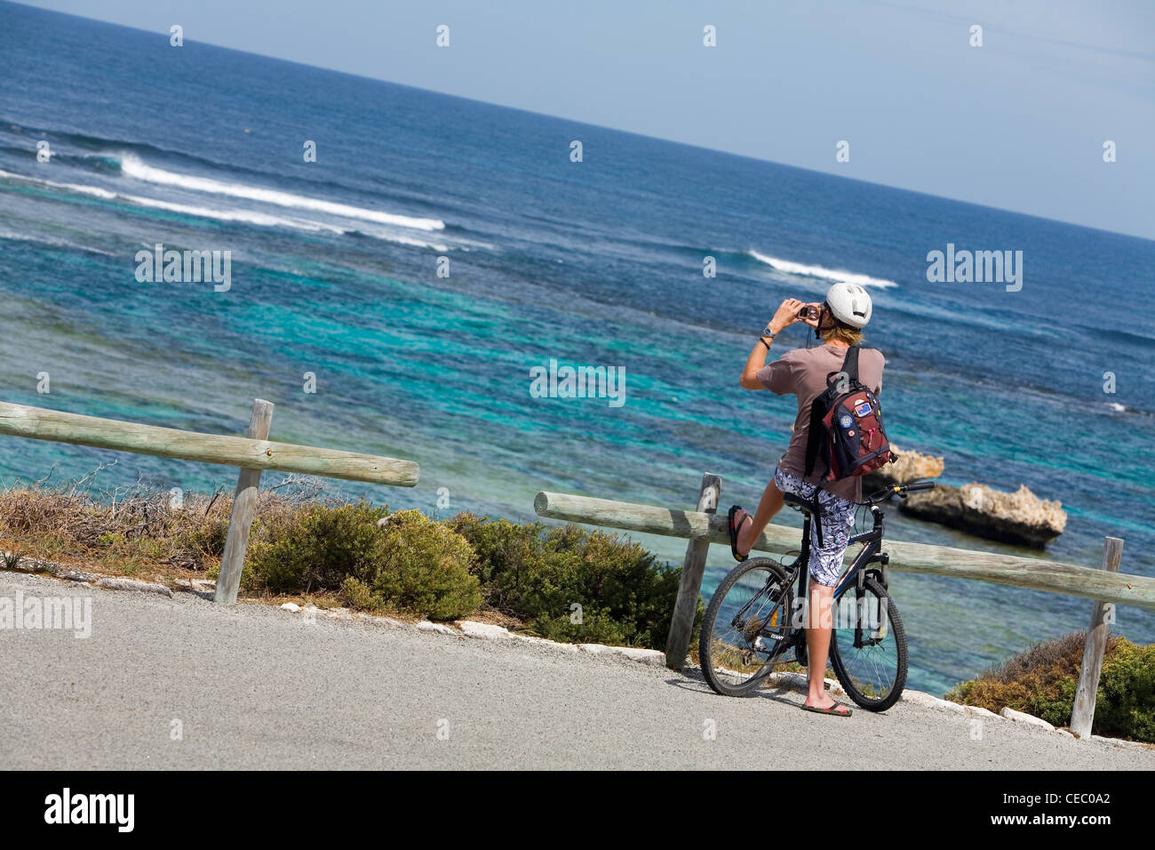 Cyclist photographing the coastline at Jeannies Lookout on Rottnest Island, Western Australia, AUSTRALIA Stock Photo