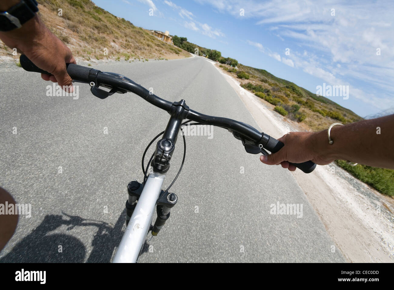 Mountain bike rider's view on country road.  Rottnest Island, Western Australia, AUSTRALIA Stock Photo