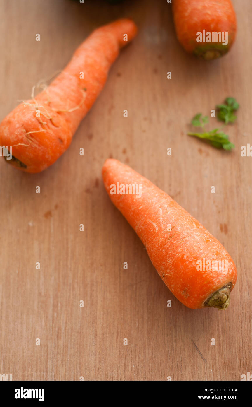 Carrots with coriander on a wooden background Stock Photo