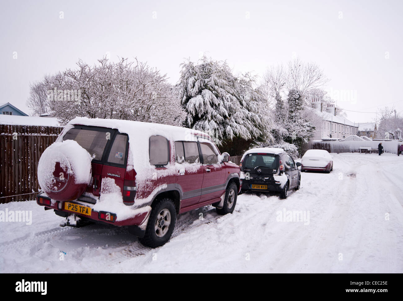 Snow Covered Street Road With Parked Cars Stock Photo - Alamy