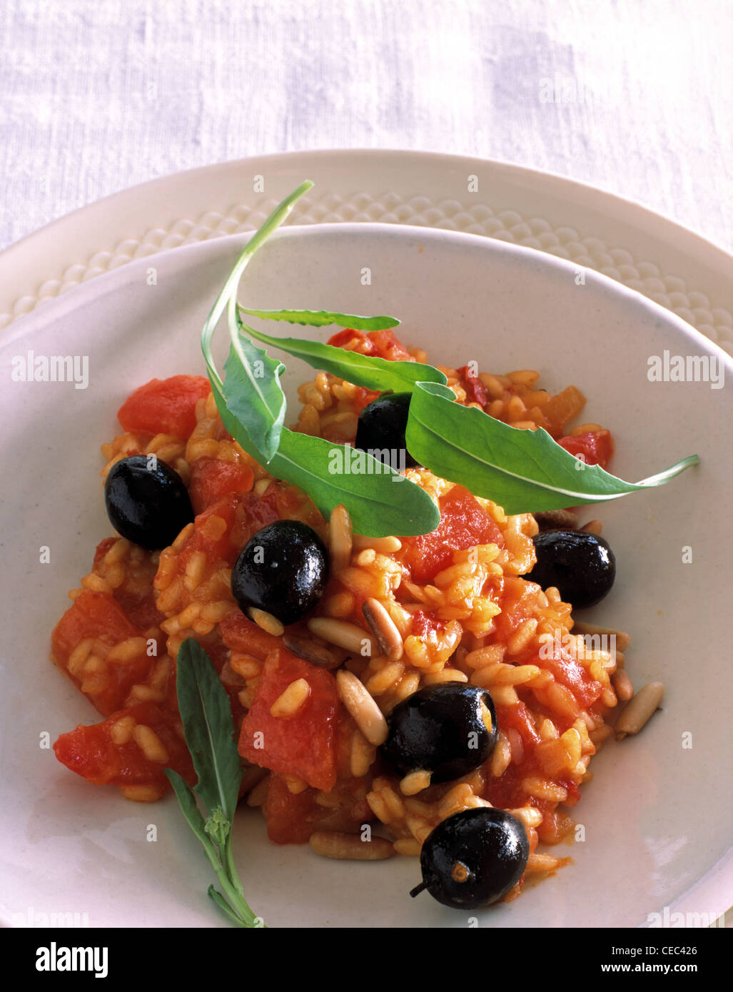 Tomato - risotto with olives Stock Photo - Alamy