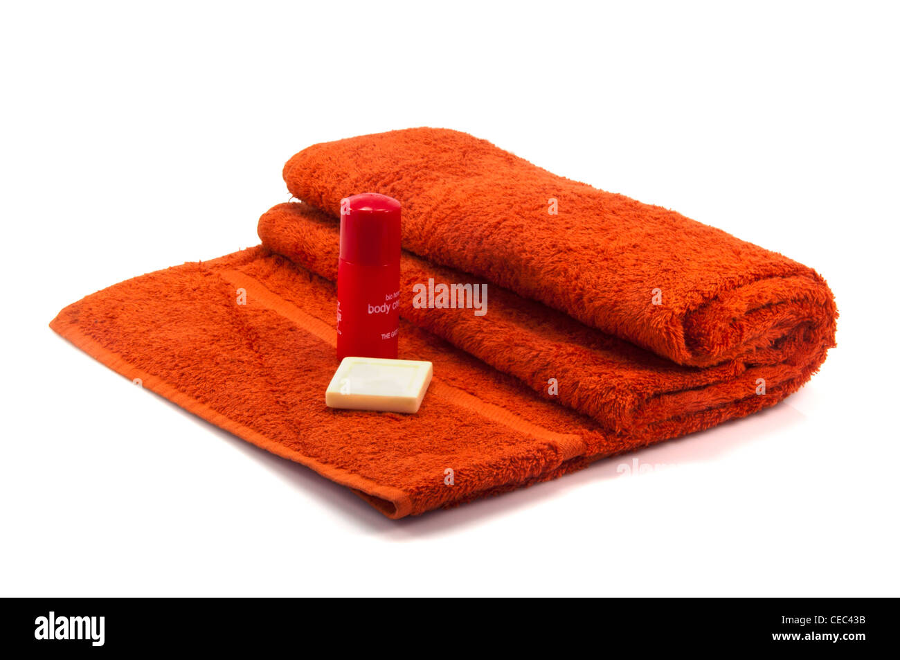 Red bath towel roll with shampoo and soap bar Stock Photo