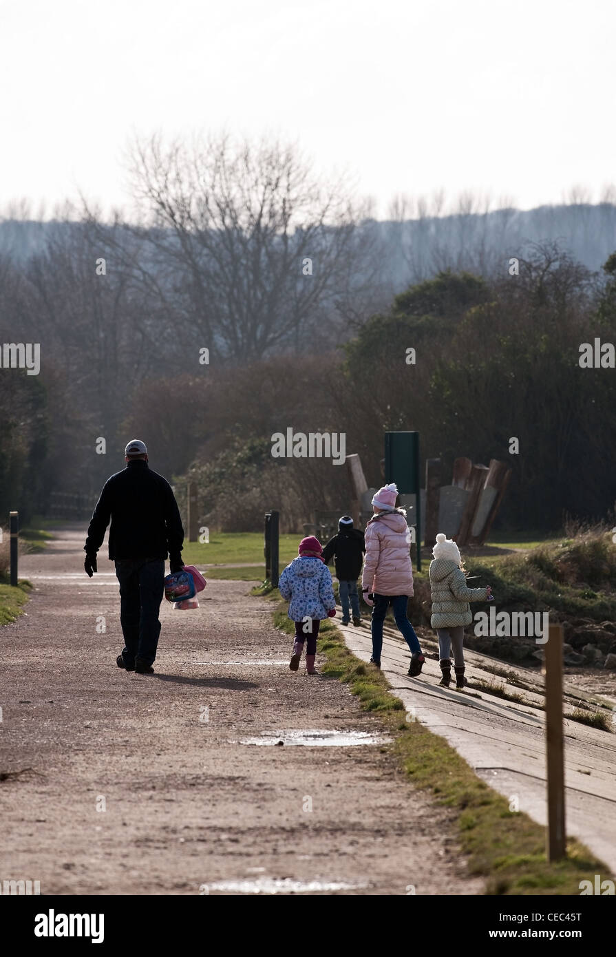 An adult and four children walking through Riverside Country Park in Kent Stock Photo