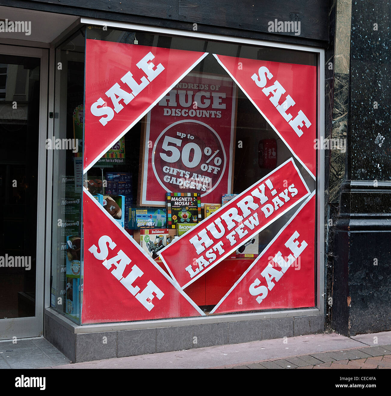 Retail Shop Window with Sale Stickers, UK. Stock Photo