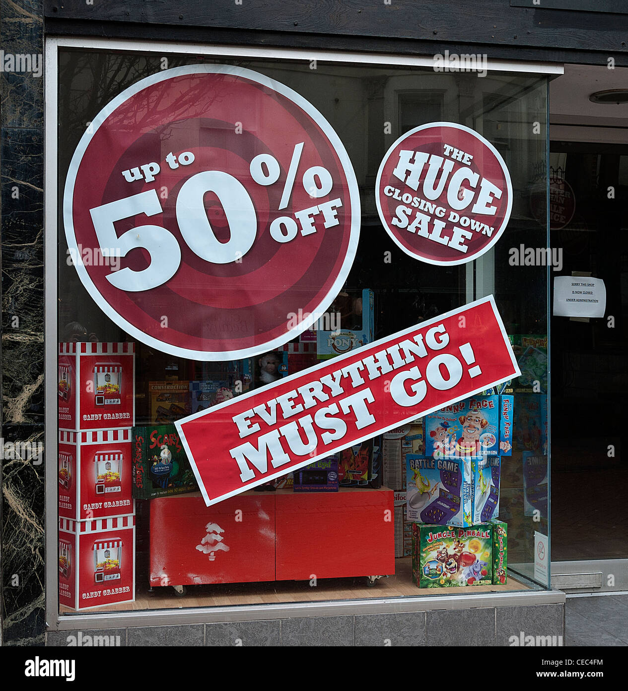 Retail Shop Window with Sale Stickers, UK. Stock Photo