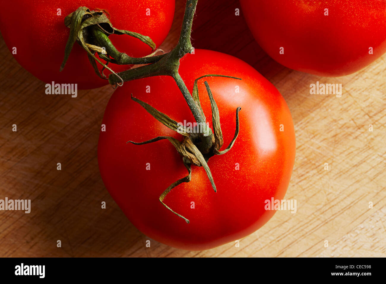 tomato on a wooden chopping board (solanum, lycopersicum Stock Photo ...