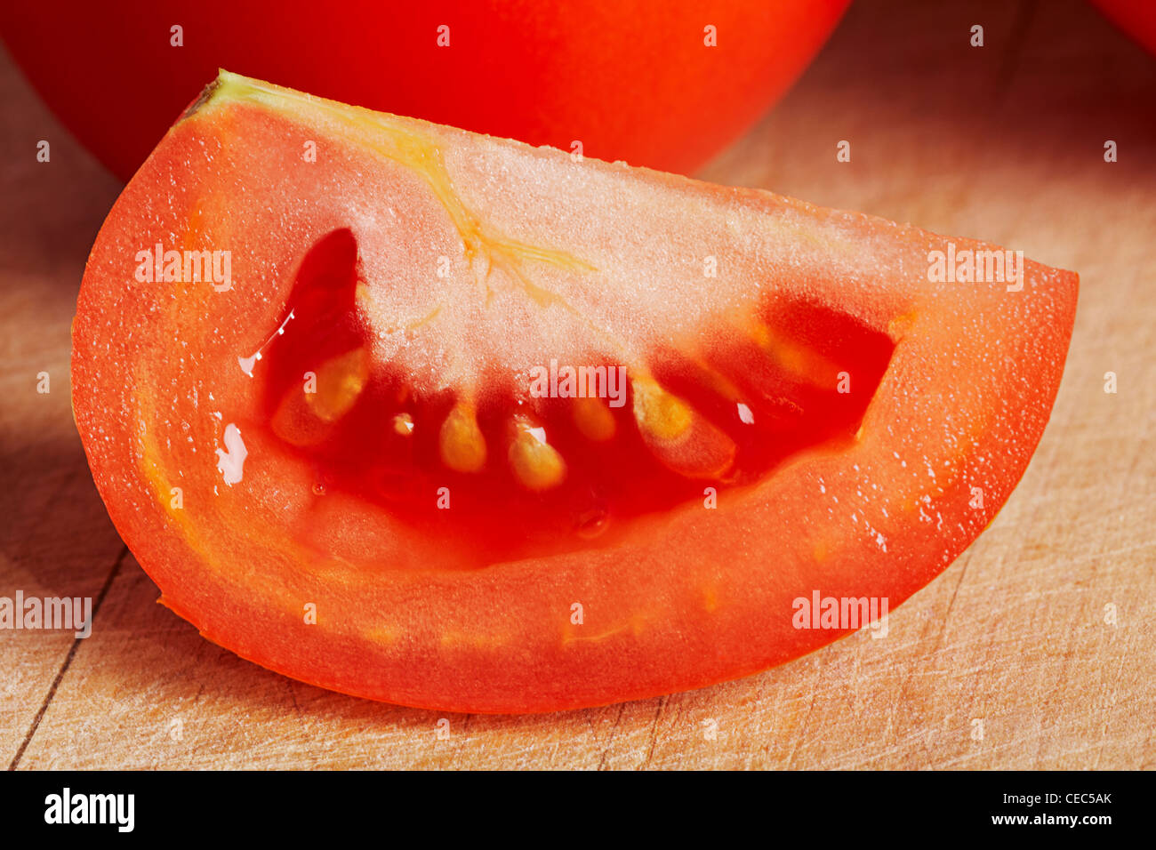tomato on a wooden chopping board (solanum, lycopersicum) Stock Photo