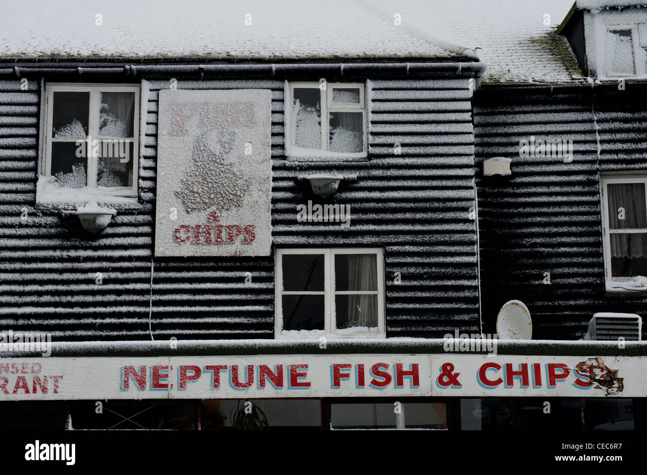 Weather boarded fish and chip shop facade in the snow. The Stade. Hastings. East Sussex. England. UK Stock Photo