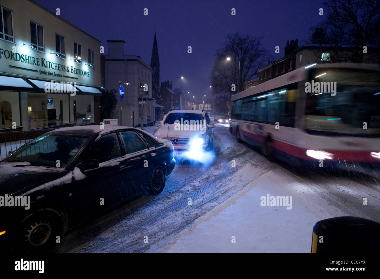 Car and bus in evening rush hour traffic in snow,snowy,wintry weather Stock Photo