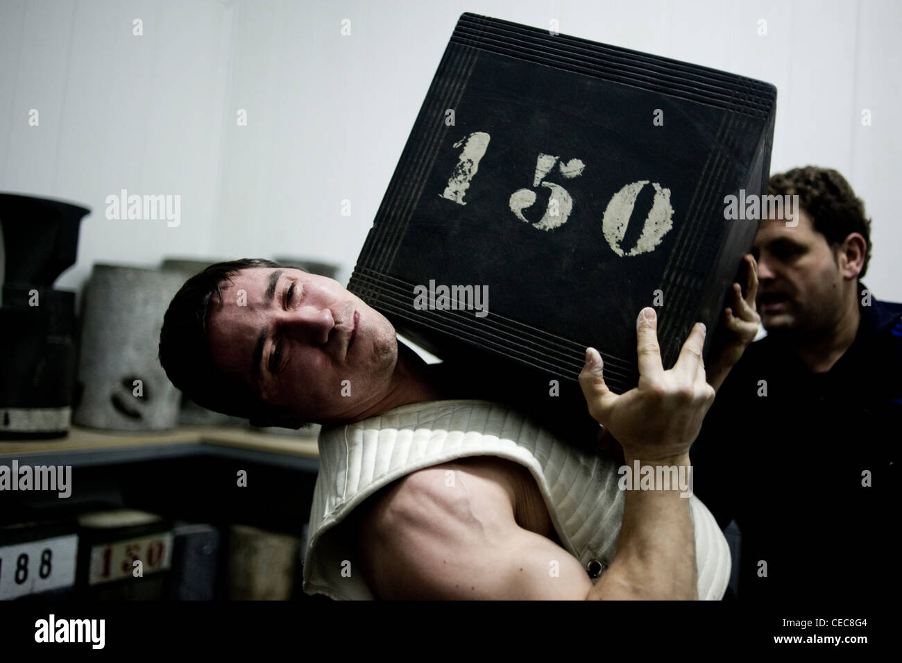 Josetxo Urrutia, stone lifter or harrijasotzaile in Basque language. He lifts a 150 kg stone during his training in Orio. Stock Photo
