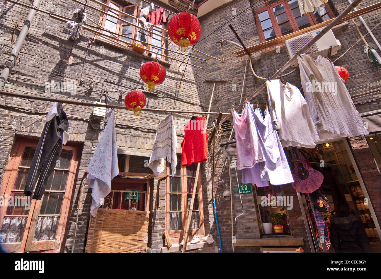 Laundry and chinese lanterns hanging in a street of Shanghai - Tianzifang, Taikang Lu, Shanghai  - China Stock Photo