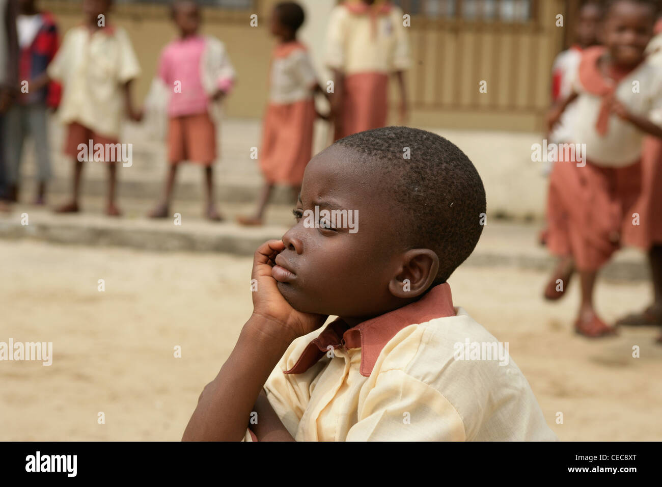 A young boy on his own durting breaktime at a  primary school, Lagos Nigeria Stock Photo