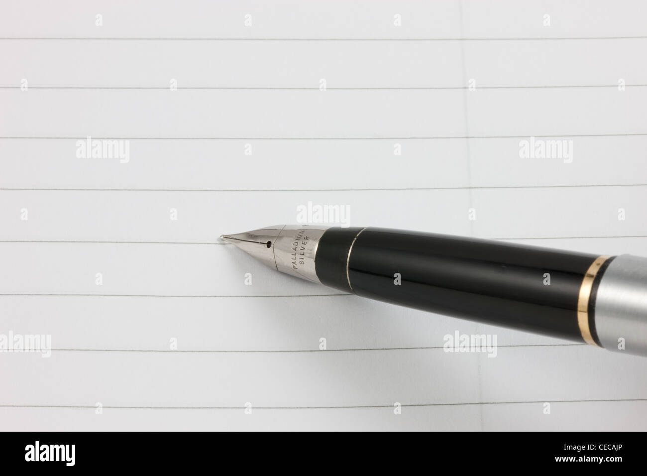 A fountain pen on a lined notepad with copy space Stock Photo Alamy