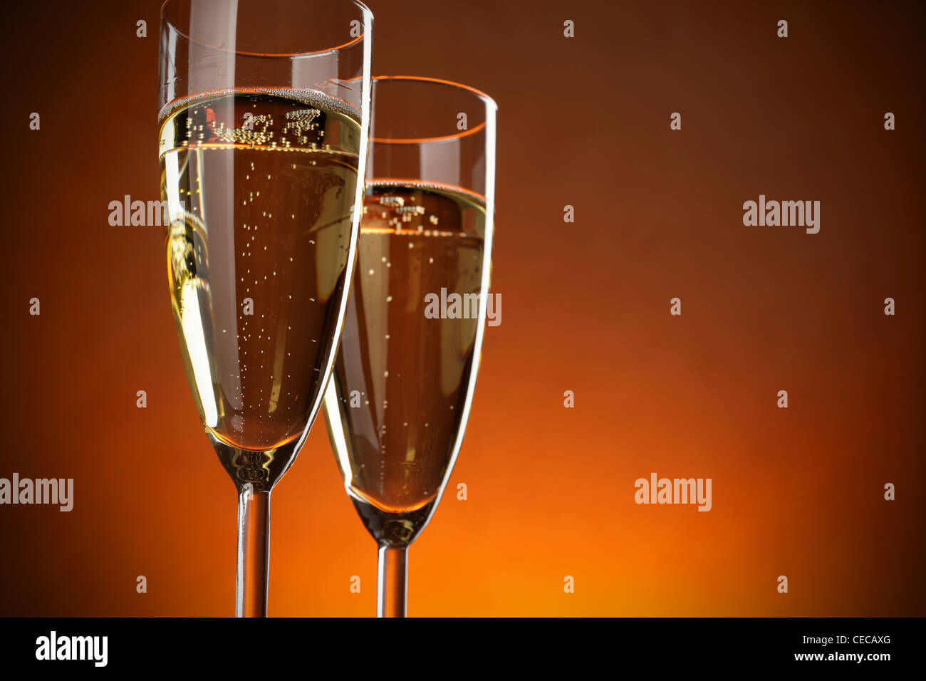 Two glasses of champagne over red background Stock Photo
