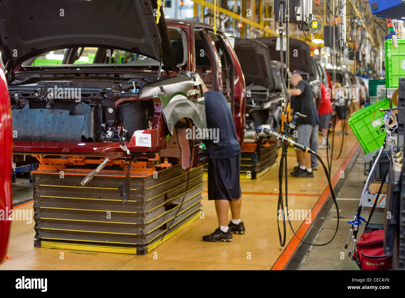 Factory workers assemble F-150 pickup trucks at the Ford River Rouge final assembly plant production line in Dearborn, Michigan Stock Photo