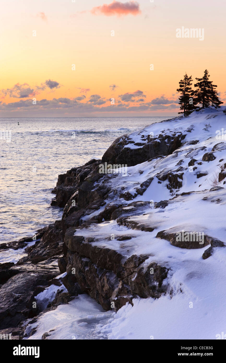 Dawn over the Atlantic Ocean in winter as seen from near Schooner Head on Maine's Acadia National Park. Stock Photo