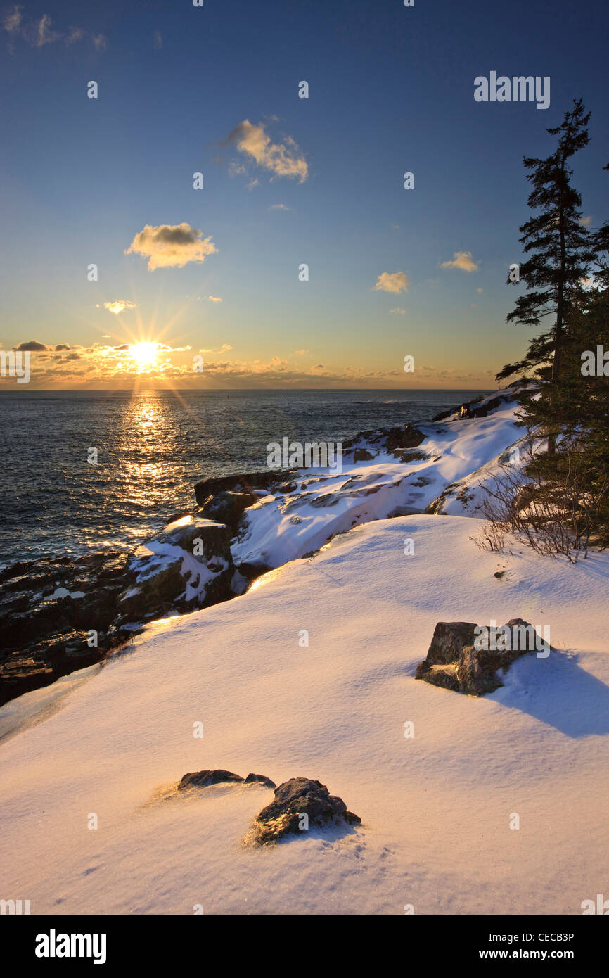 Sunrise over the Atlantic Ocean in winter as seen from near Schooner Head on Maine's Acadia National Park. Stock Photo