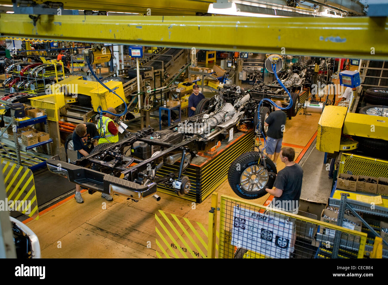Factory workers assemble the chassis of F-150 pickup trucks at the Ford River Rouge production line in Dearborn, Michigan. Stock Photo