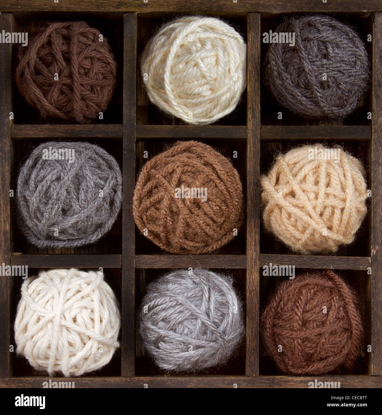 Assorted balls of natural colored yarn in a printers box Stock Photo