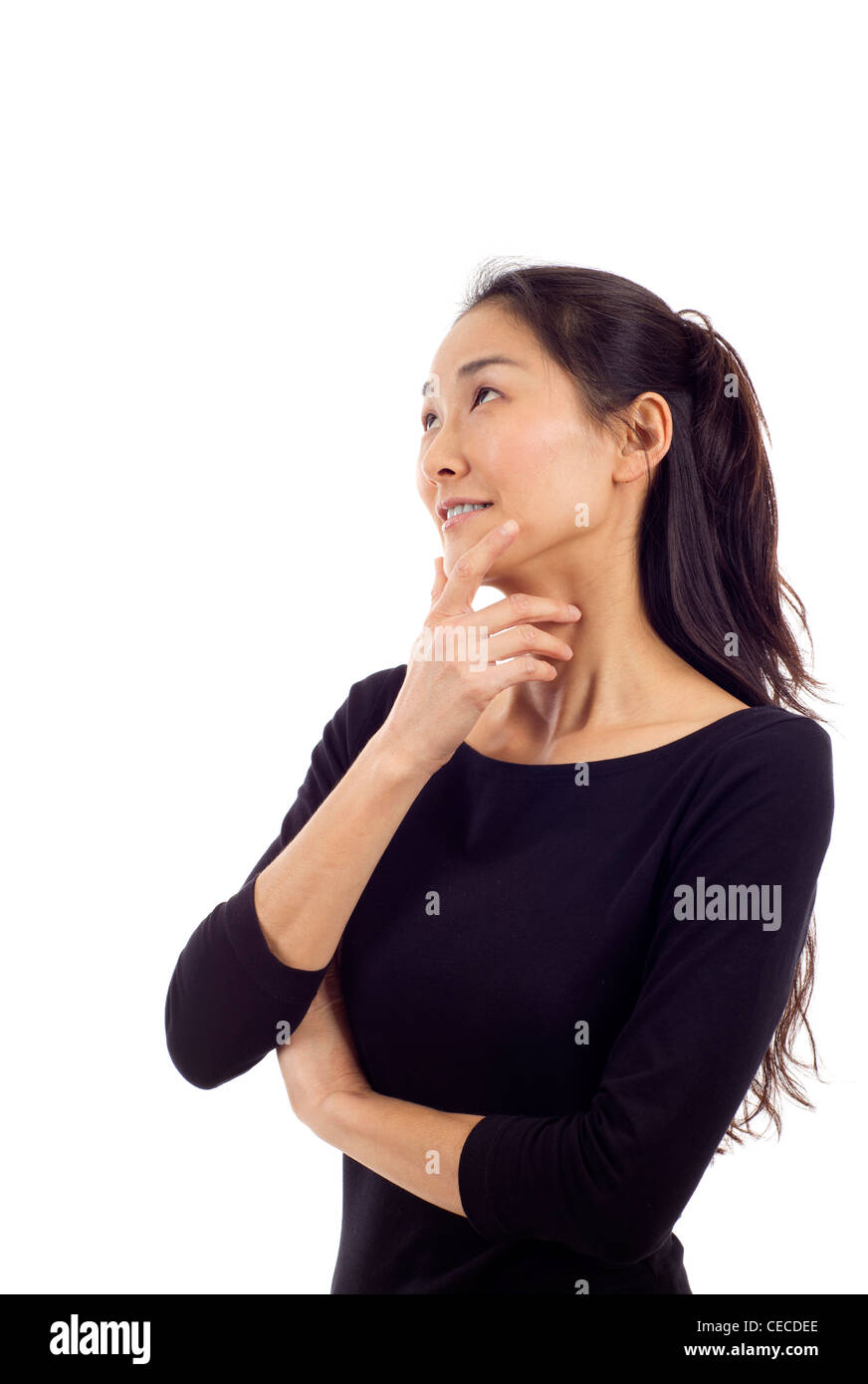 Beautiful thoughtful Asian woman looking up isolated over white Stock ...