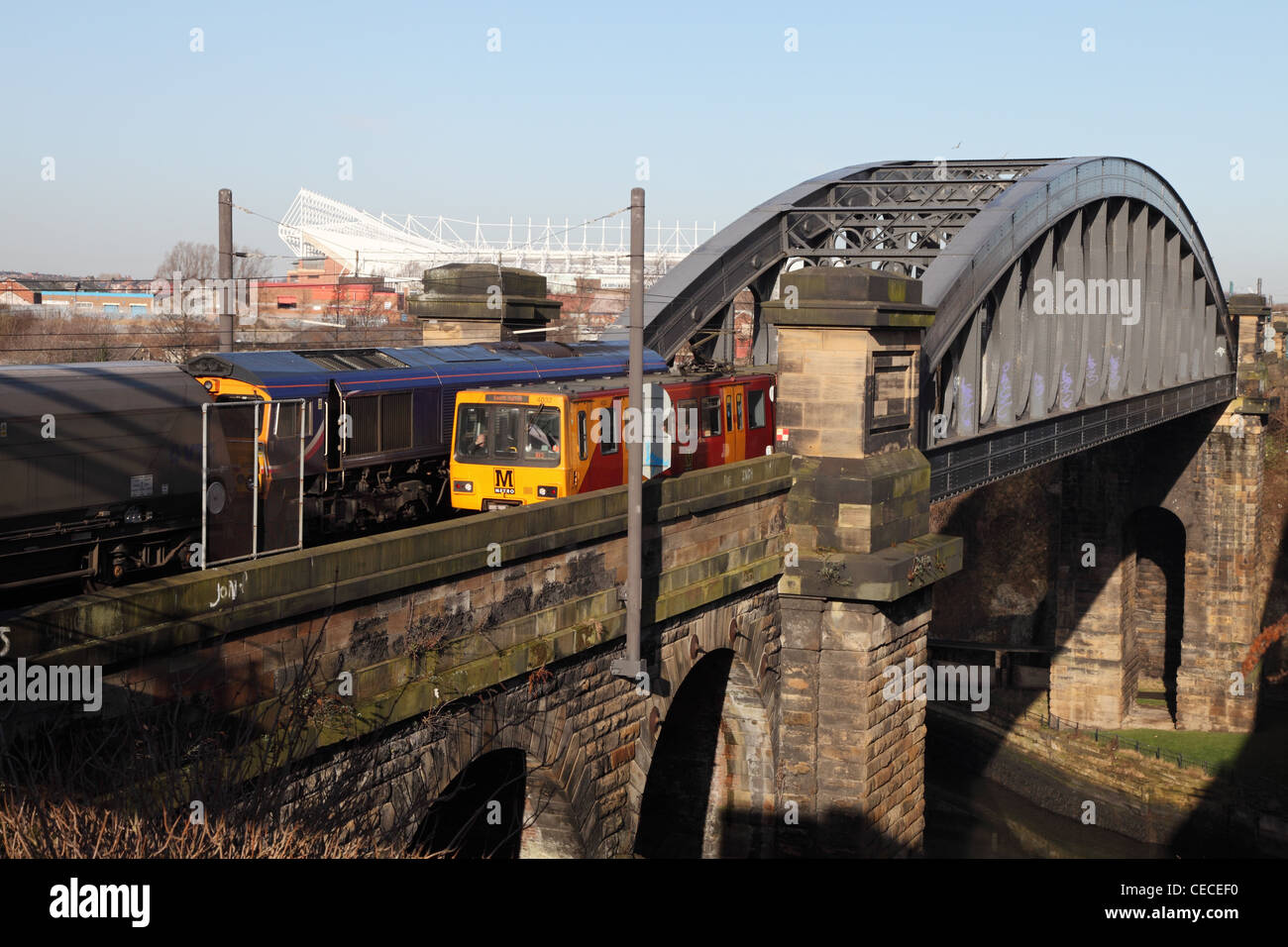 A Tyne and Wear Metro train passes a coal train on Wearmouth rail bridge Sunderland north east England UK Stock Photo