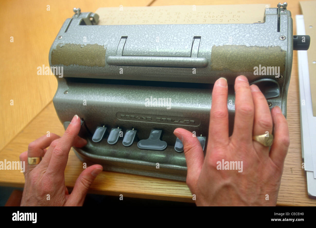 Blind person learning to use a Braille machine at a guide dogs for the