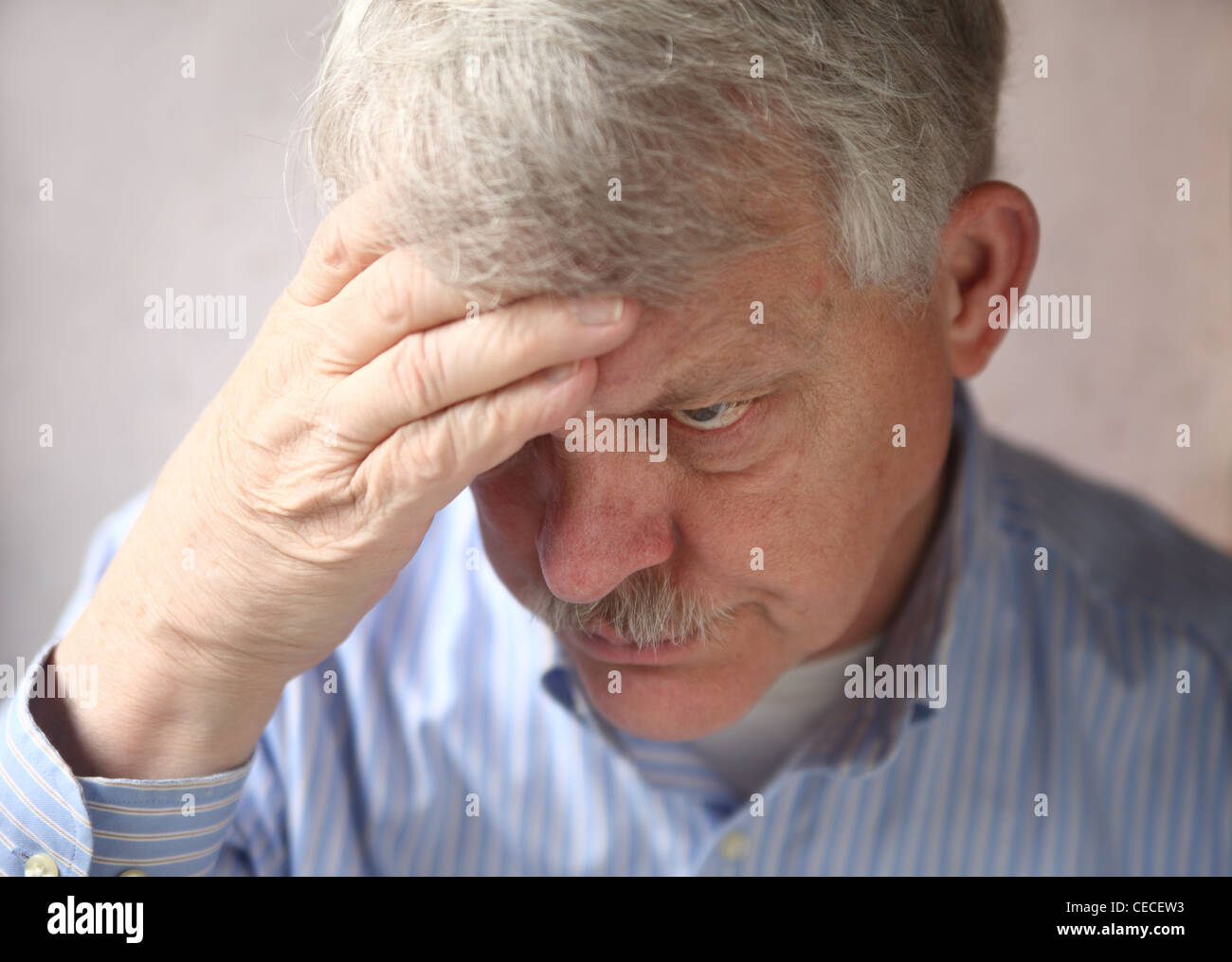 older man showing signs of annoyance, irritability and paranoia Stock Photo Alamy