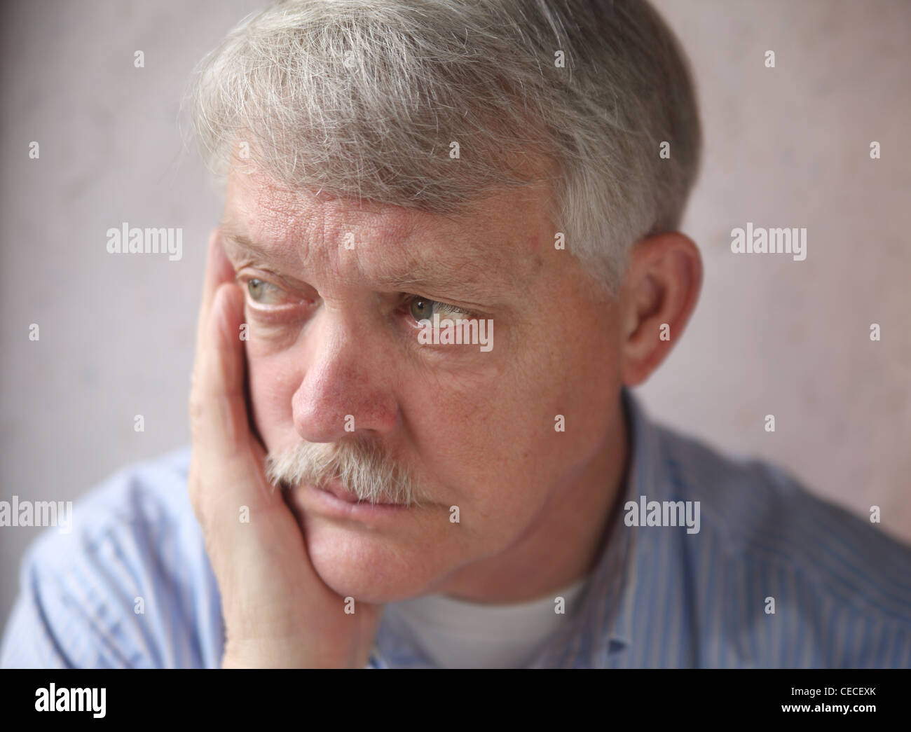 senior man with an angry, troubled expression Stock Photo