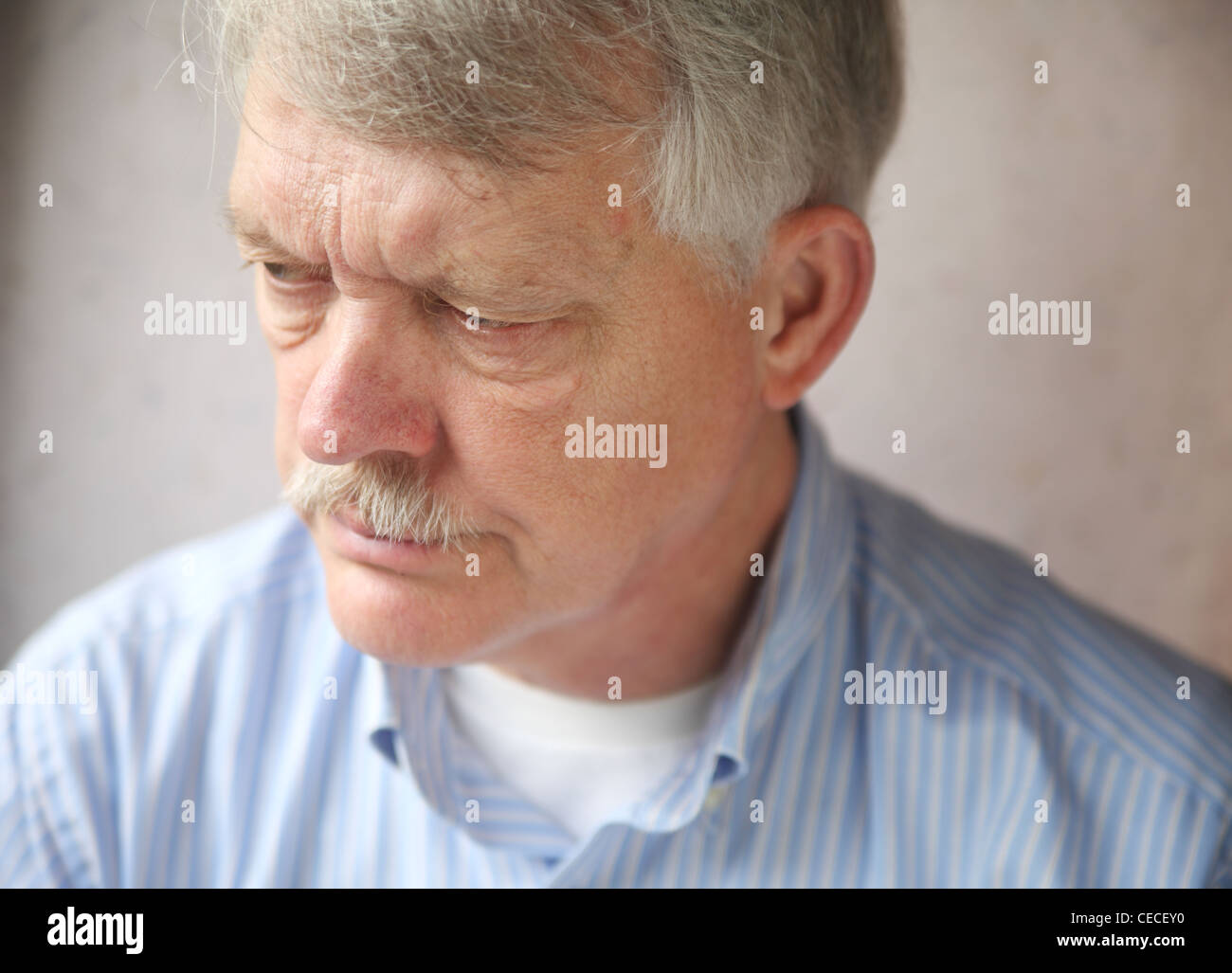 senior man with an angry, troubled expression Stock Photo