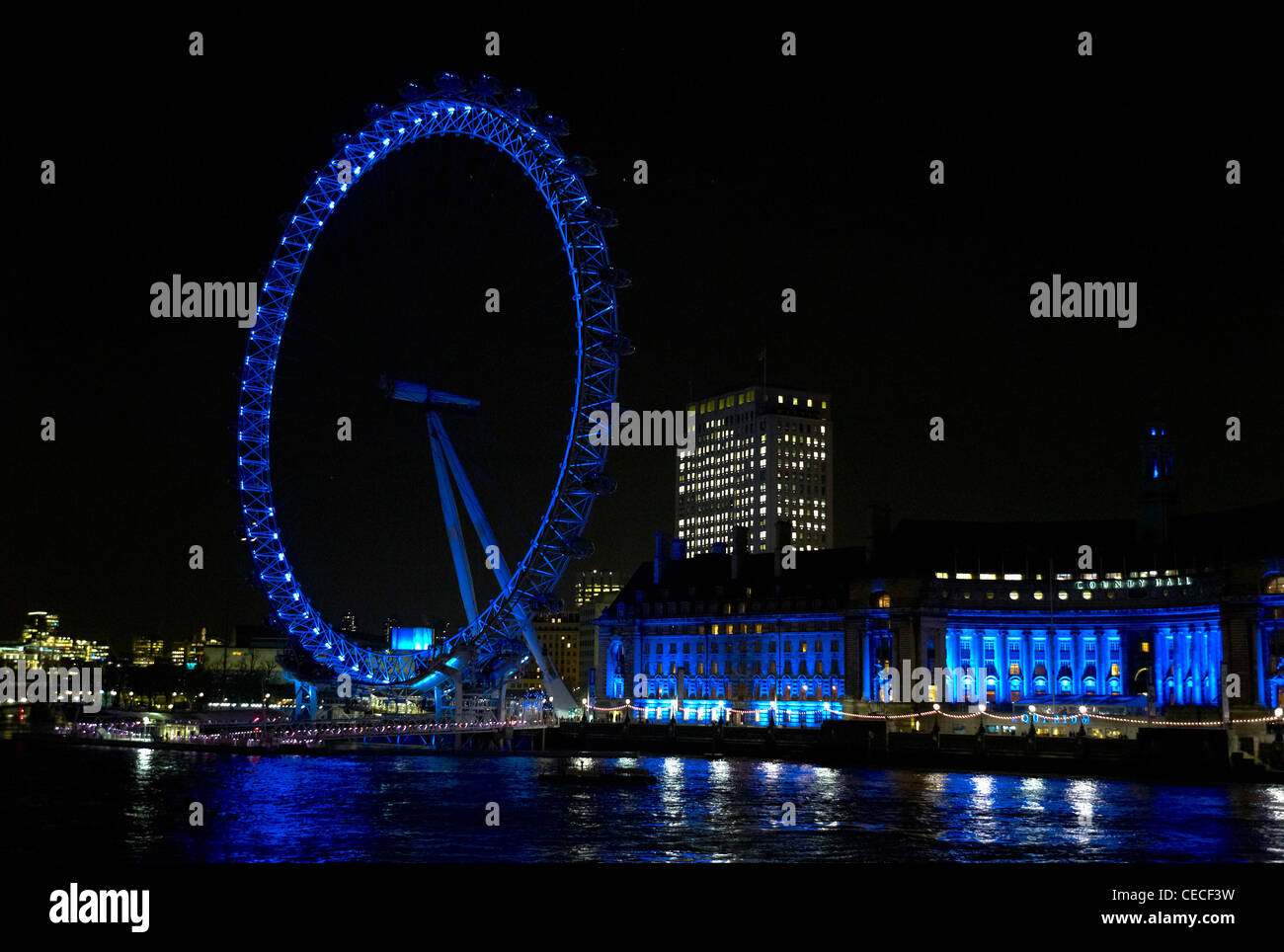 London Eye at night lit up in blue lights Feb 2012 London England Stock Photo