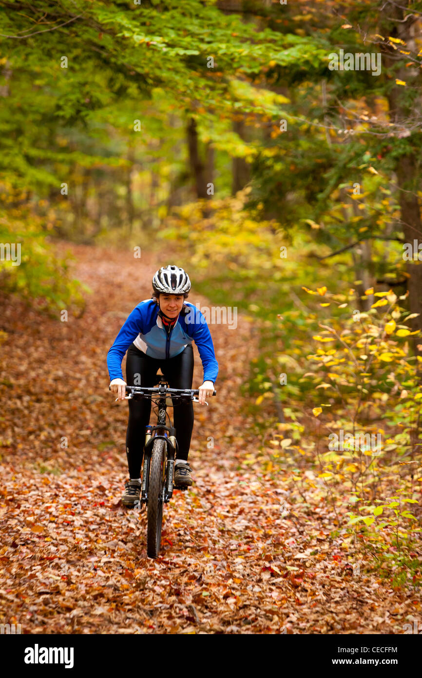 A woman mountain biking on a trail on Millstone Hill in Barre, Vermont
