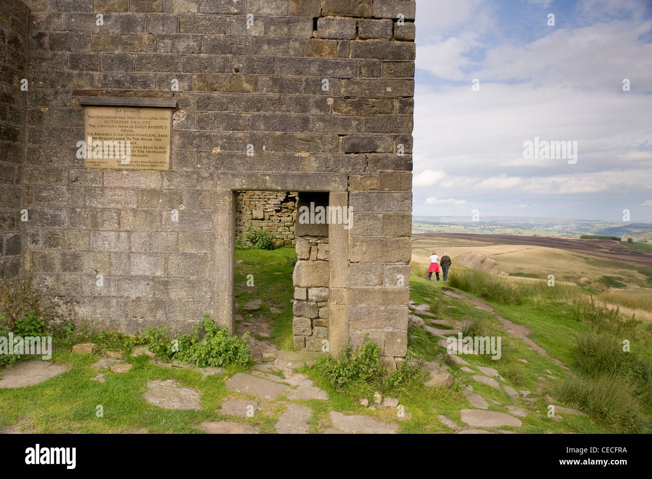 Walkers by Top Withens, crumbling farmhouse ruin on wild remote Pennine moors (Wuthering Heights?) - summer near Haworth, West Yorkshire, England, UK. Stock Photo