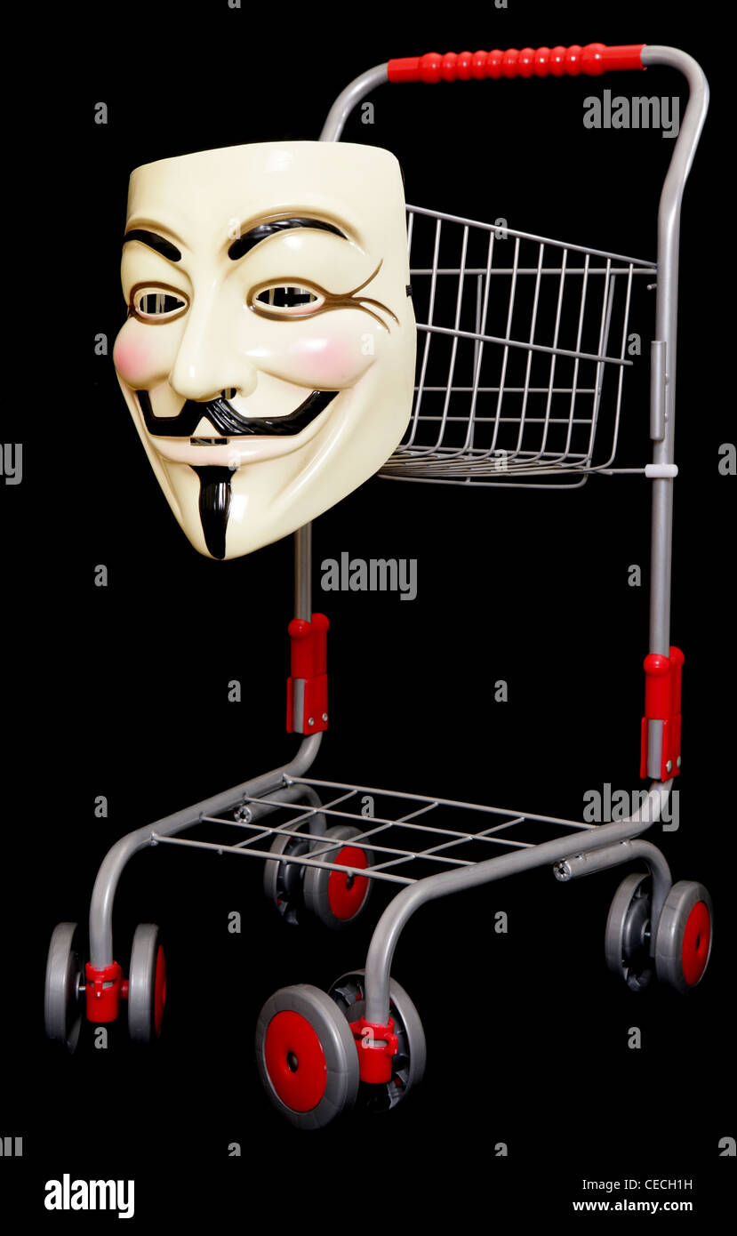 Guy fawkes mask with a shopping trolley on black background Stock Photo